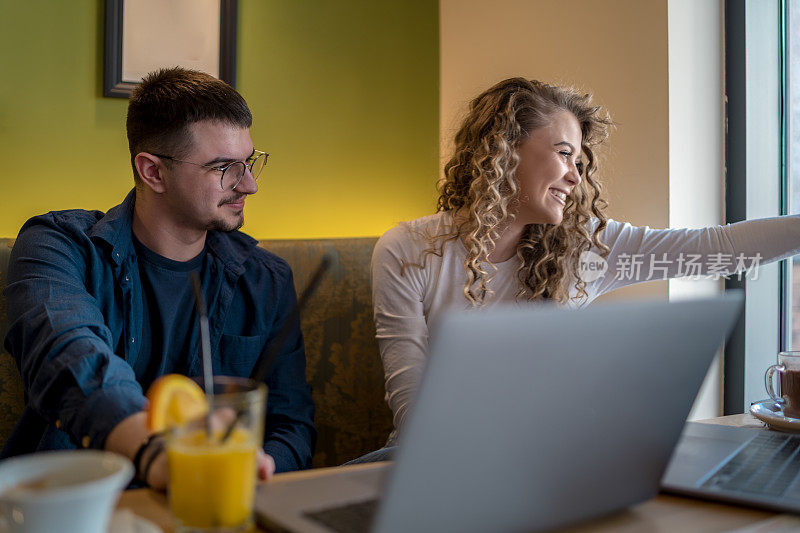 Business people working together at a café using their laptops